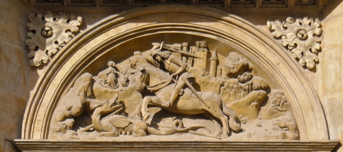 St. George slaying a dragon, woodcarving over side door of cathedral in Prague.